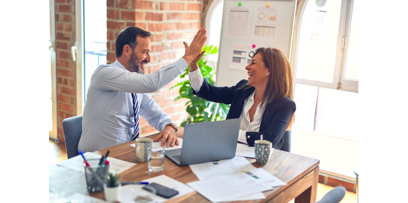 A man and woman giving each other a high five